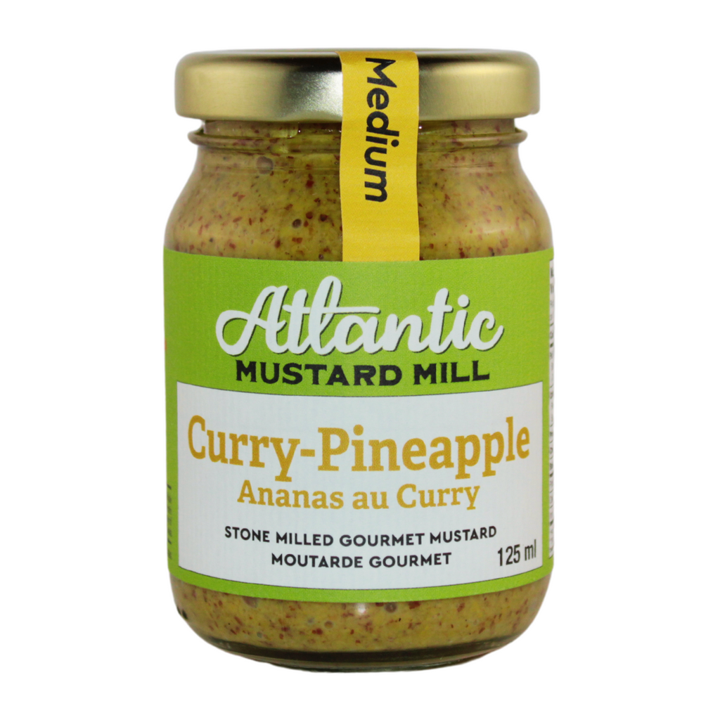 A jar of curry mustard with pineapple