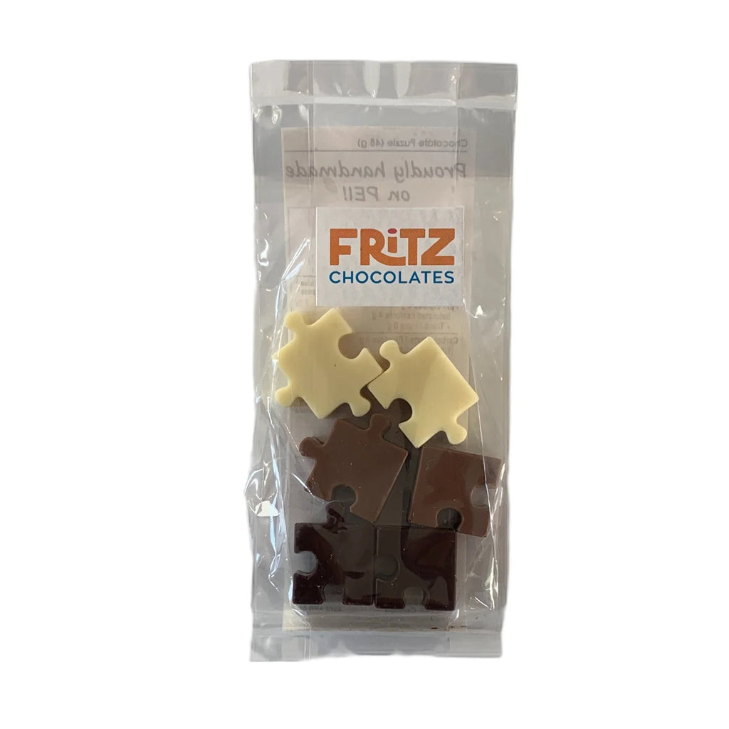 Packaged chocolate pieces shaped like puzzle piece, branded as Fritz Chocolates.