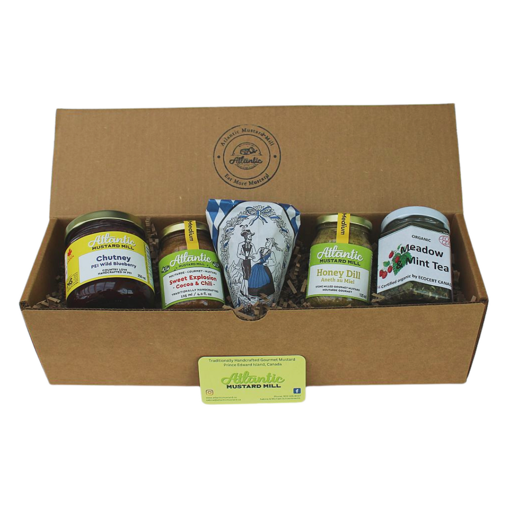 A box with a Blueberry Chutney, A sweet Explosion mustard, glazed almonds, a Honey Dill mustard and a Meadow mind tea